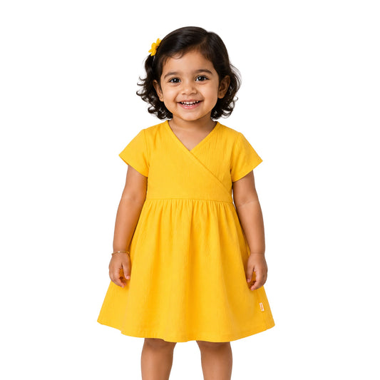 Milou Girls Wrap Neck A-Line Dress in yellow, worn on model